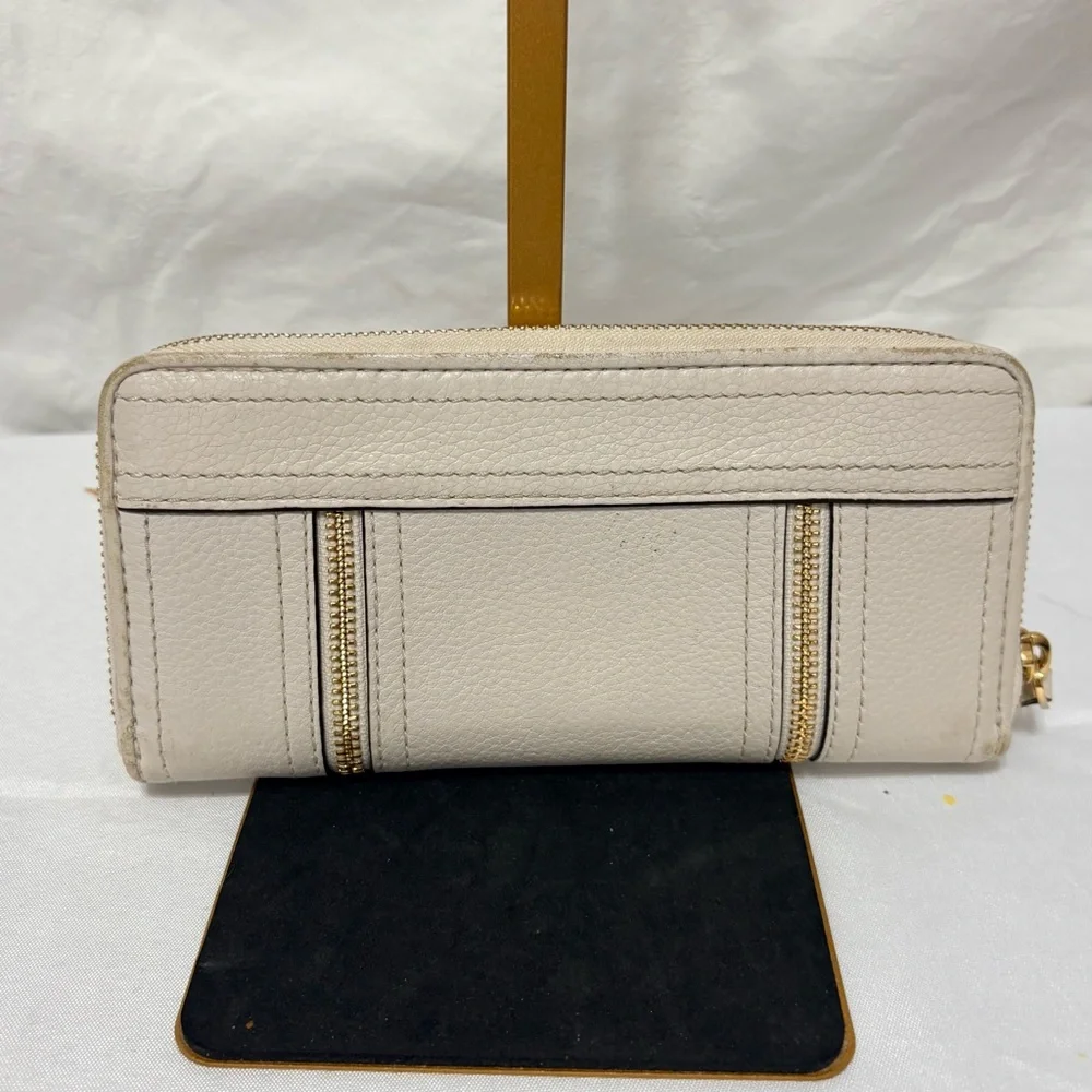 Michael Kors Moxley continental zip-around wallet in vanilla or cream leather.